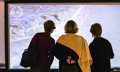 People viewing a scientific projection